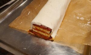 folding the puff pastry over the stack of tofu