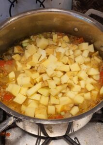 adding chopped cubed potatoes