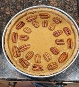 filling poured in with pecans on top
