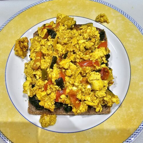 Scrambled tofu on toast with a bed of spinach