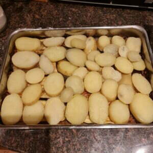 Adding in the final layer of potatoes