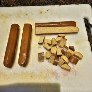 Cutting the tofu weiner sausages into small pieces