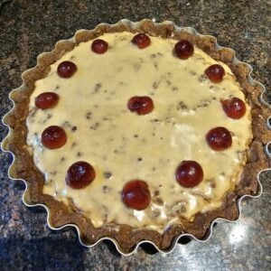 placing the cherries on the tart
