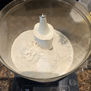 weighing the flour salt & ground seeds into a mixer bowl