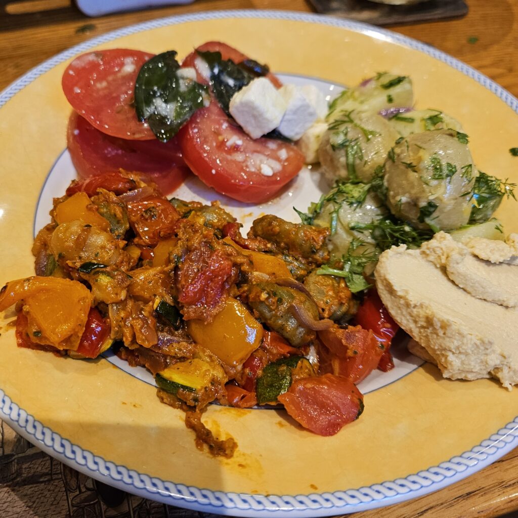 pesto gnocci with hummus, Greek tomato salad & herby summer salad