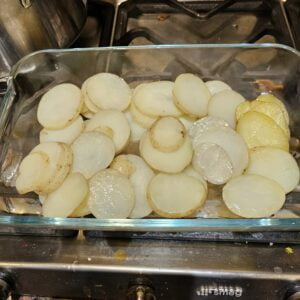 half the steamed sliced potatoes