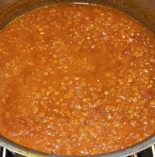 adding in the lentils to cook on